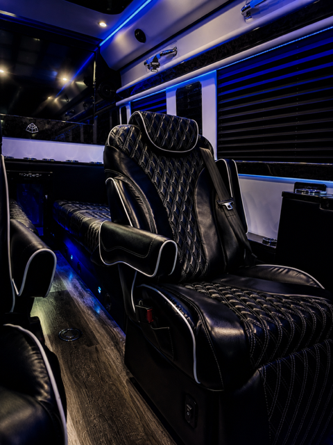 Executive Sprinter cabin with diamond-stitched captain chairs and ambient lighting